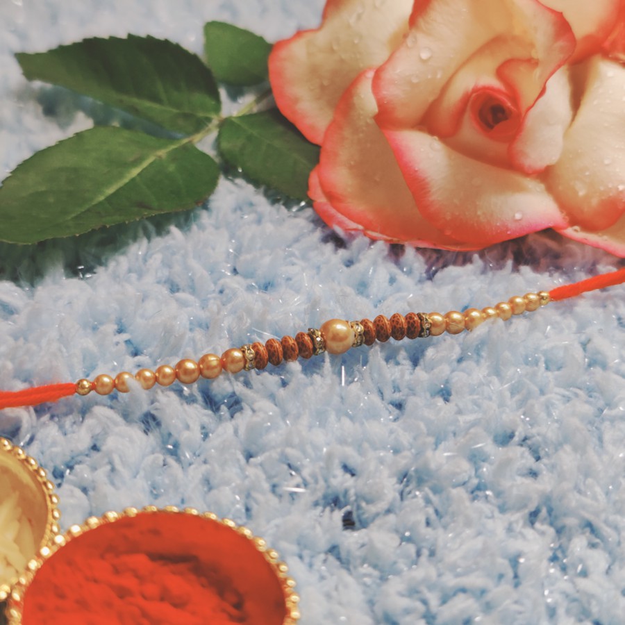 House of Festivals Dori Rakhi - With Cream & Wodden Pearl Beads