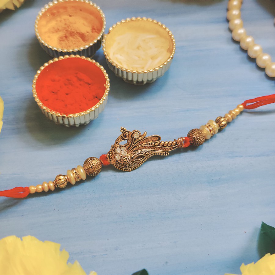 House of Festivals Peacock Golden Pendant Rakhi - With Beads