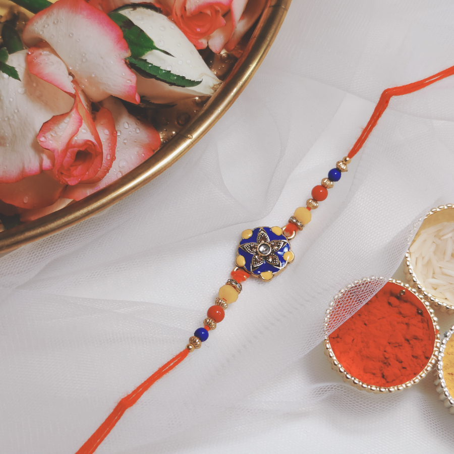 House of Festivals Premium Flower Rakhi - With Blue & Yellow Metal Work & Beads