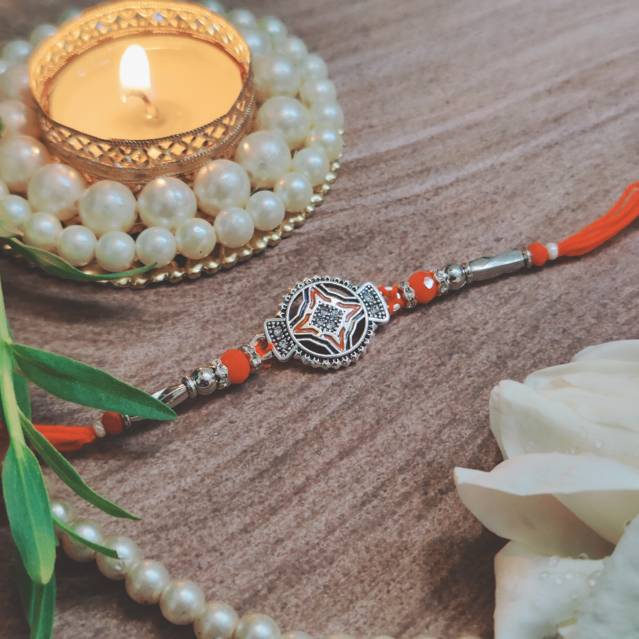 House of Festivals Silver Design Rakhi - With Red Pearl Beads